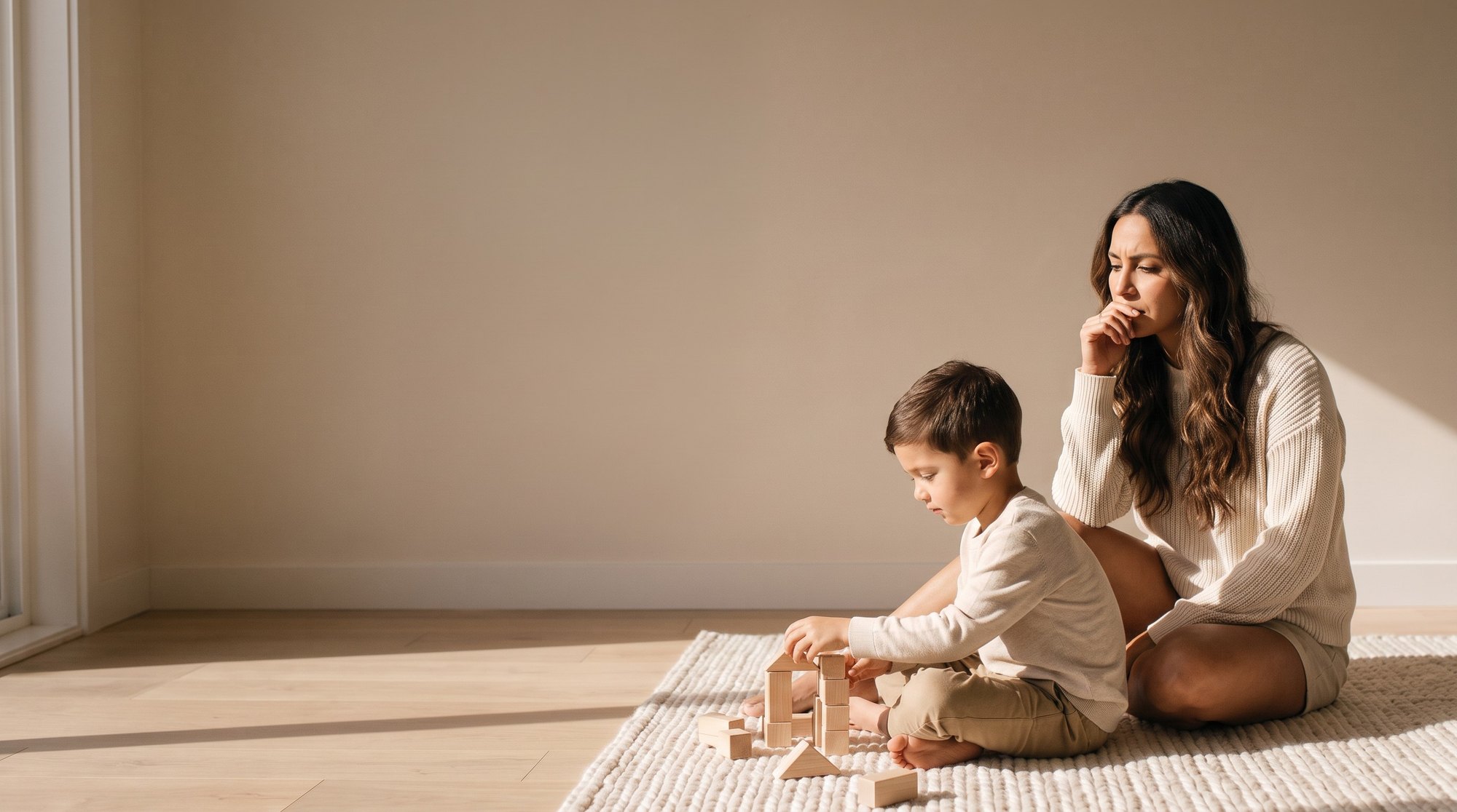 A worried mother watching her son play with wooden blocks
